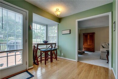 View of breakfast area.  Features include hardwood floors, two inch blinds, and bay window.