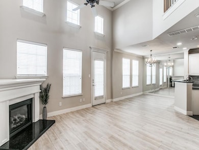 Living area with visible vents, a premium fireplac