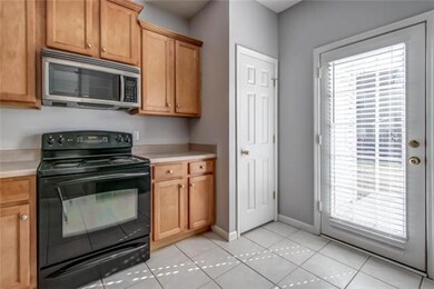 Kitchen with tile floor. Refrigerator remains.  