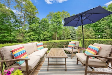 Patio Seating Area Surrounded by Lush Greenery