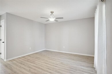 Living Room with new ceiling fan. Freshly painted.