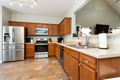 The open living room flows into the kitchen with a raised bar.  Stainless steel appliances and great cabinet space.
