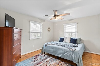 Bedroom featuring baseboards, multiple windows, ce