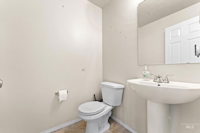 Half bathroom featuring toilet and a sink