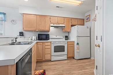 Kitchen featuring under cabinet range hood, light 