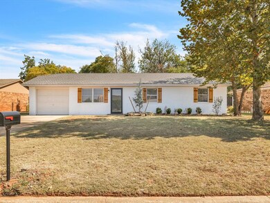 Ranch-style home featuring a front lawn and a gara
