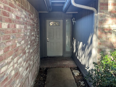 View of exterior entry featuring brick siding