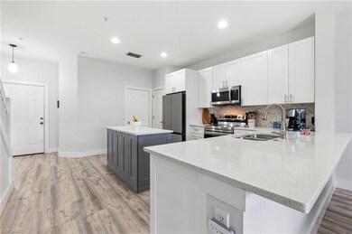 Kitchen with stainless steel appliances, hanging l