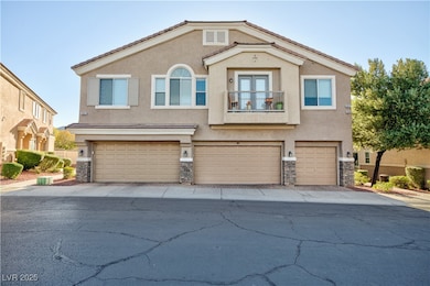 Mediterranean / spanish home featuring a balcony, stucco siding, stone siding, and a garage