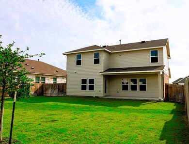 Back of property featuring a patio and roof with 