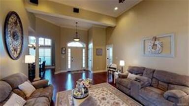 The Great Room features high ceilings and crown mo
