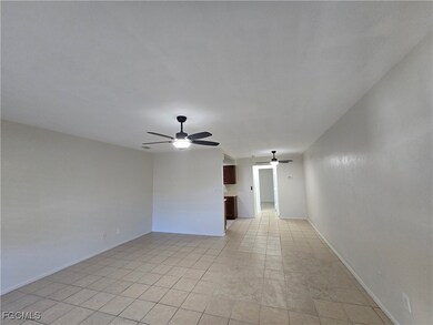 Empty room featuring a ceiling fan and light tile patterned flooring
