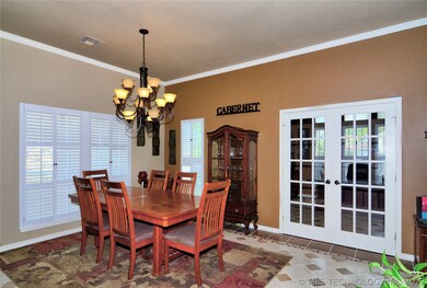 Formal dining area with upscale lighting fixture.