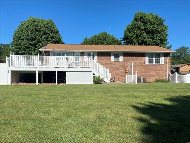 All brick home with vinyl fence and deck.