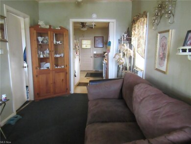 Partial view of L-shaped living room and kitchen f