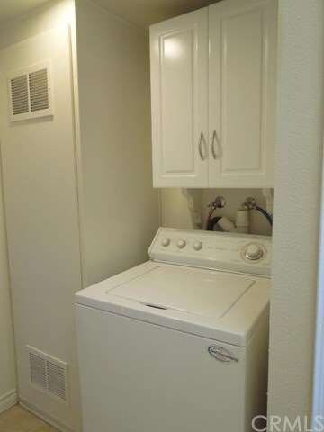 Laundry room has extra storage and holds standard 
