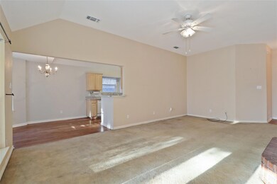 Living room with view into the kitchen.