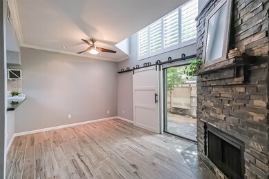 Enjoy stylish wood-look tile floors on the main level, complemented by a sliding barn door that offers privacy to the patio area.