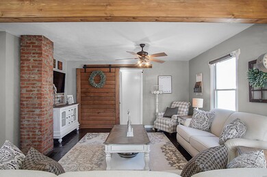 Living room. Exposed brick, barn door into master 