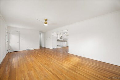 Unfurnished living room featuring crown molding, b