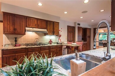 The eat-in kitchen features a breakfast bar, walk-