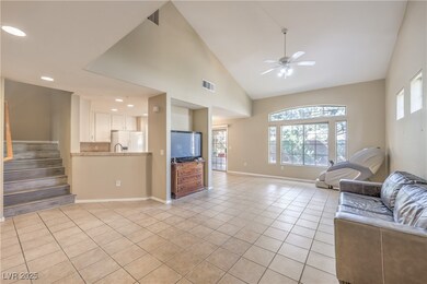 Unfurnished living room featuring a ceiling fan, l