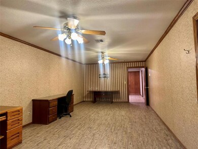 Unfurnished office with ceiling fan, ornamental molding, a textured ceiling, and light hardwood / wood-style floors