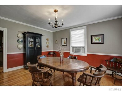 Large dining room with chair & crown moldings.