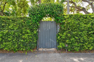 Lushly landcaped Gated arched arbor pedestrian entry