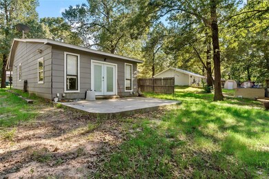 Back of house featuring a patio, a shed, and a law