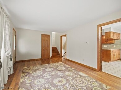 Empty room featuring light wood finished floors and stairs