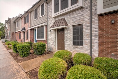 View of exterior entry with brick siding