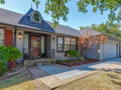 View of front of property with covered porch and a garage