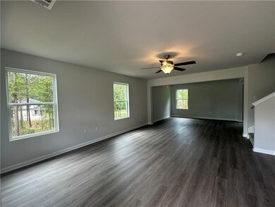 Unfurnished room with dark wood finished floors and a ceiling fan