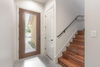Foyer entrance with stairway and concrete floors