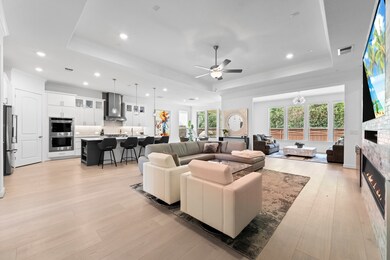 Elegant Open-Concept Living with Tray Ceilings & C