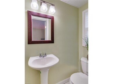 The half bath has updated lighting, ceramic tiled 