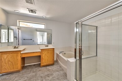 Bathroom featuring a bath, visible vents, a sink,