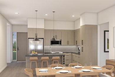 Kitchen with pendant lighting, stainless steel appliances, modern cabinets, a kitchen breakfast bar, and backsplash