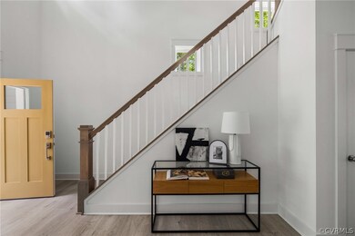 Stairway featuring light wood-type flooring