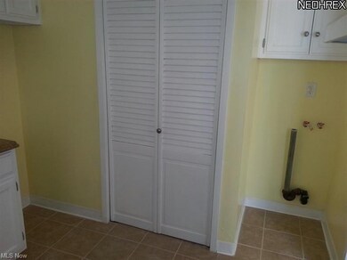 Kitchen pantry and area for washing machine.
