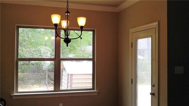 Dining area with crown molding and is open to kitc