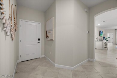 Hallway featuring arched walkways, light tile patt