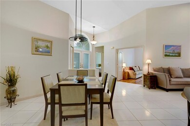 Dining space featuring an abundance of natural light, tile floors, and vaulted ceiling
