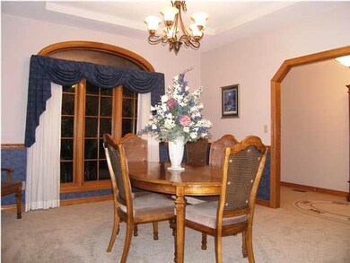 The formal dining room has an elliptical window to