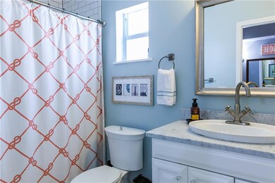 Master bath with Subway tile and marble top vanity and low flow toilet.