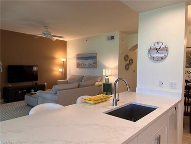 Kitchen with white cabinets, light quartz countert