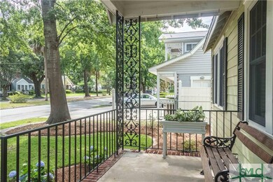 Walkway leads to warm, welcoming front porch with 