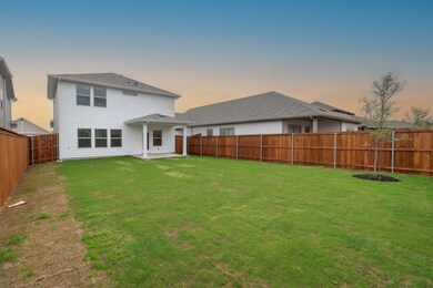 Rear view of property with a fenced backyard and a