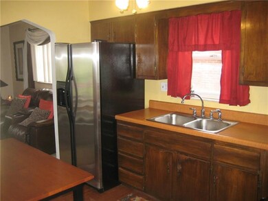 The kitchen includes hardwood floors and stainless